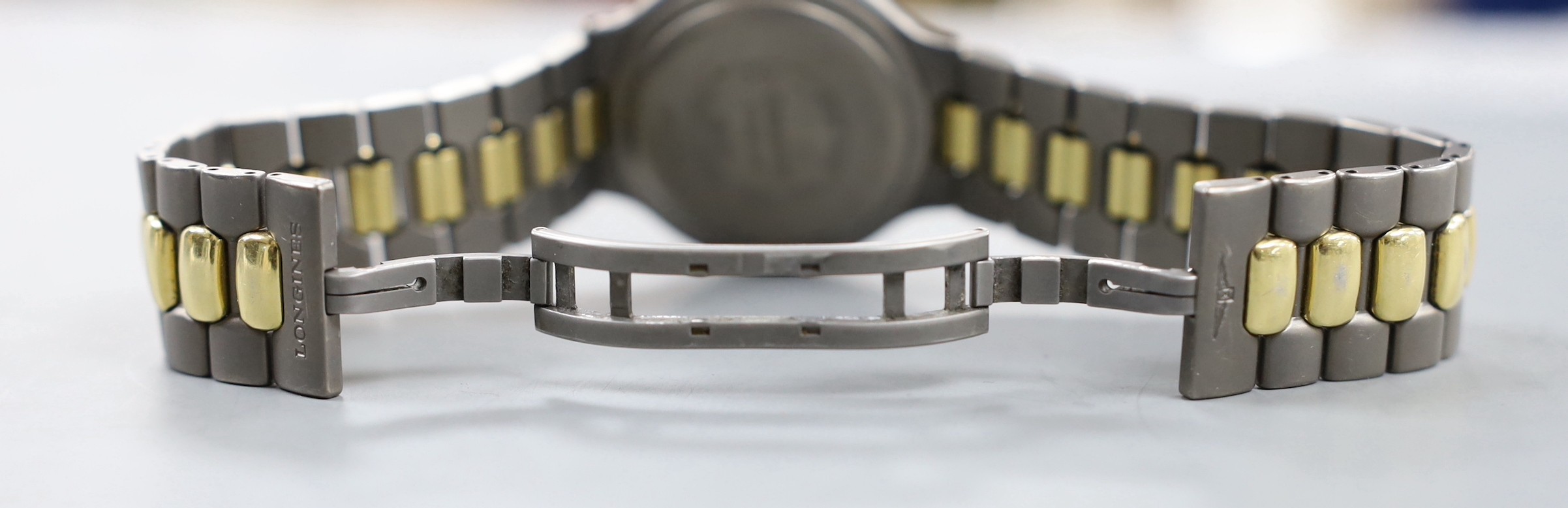 A gentleman's modern steel? and gold plated Longines TI VHP Quartz wristwatch, with box and some papers.